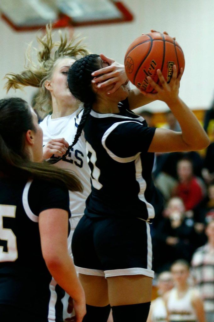 Lynnwoods Aniya Hooker gets hit in the face on a shot against Arlington during the 3A District One Semifinals on Wednesday, Feb. 14, 2024, at Marysville Pilchuck High School in Marysville, Washington. (Ryan Berry / The Herald)