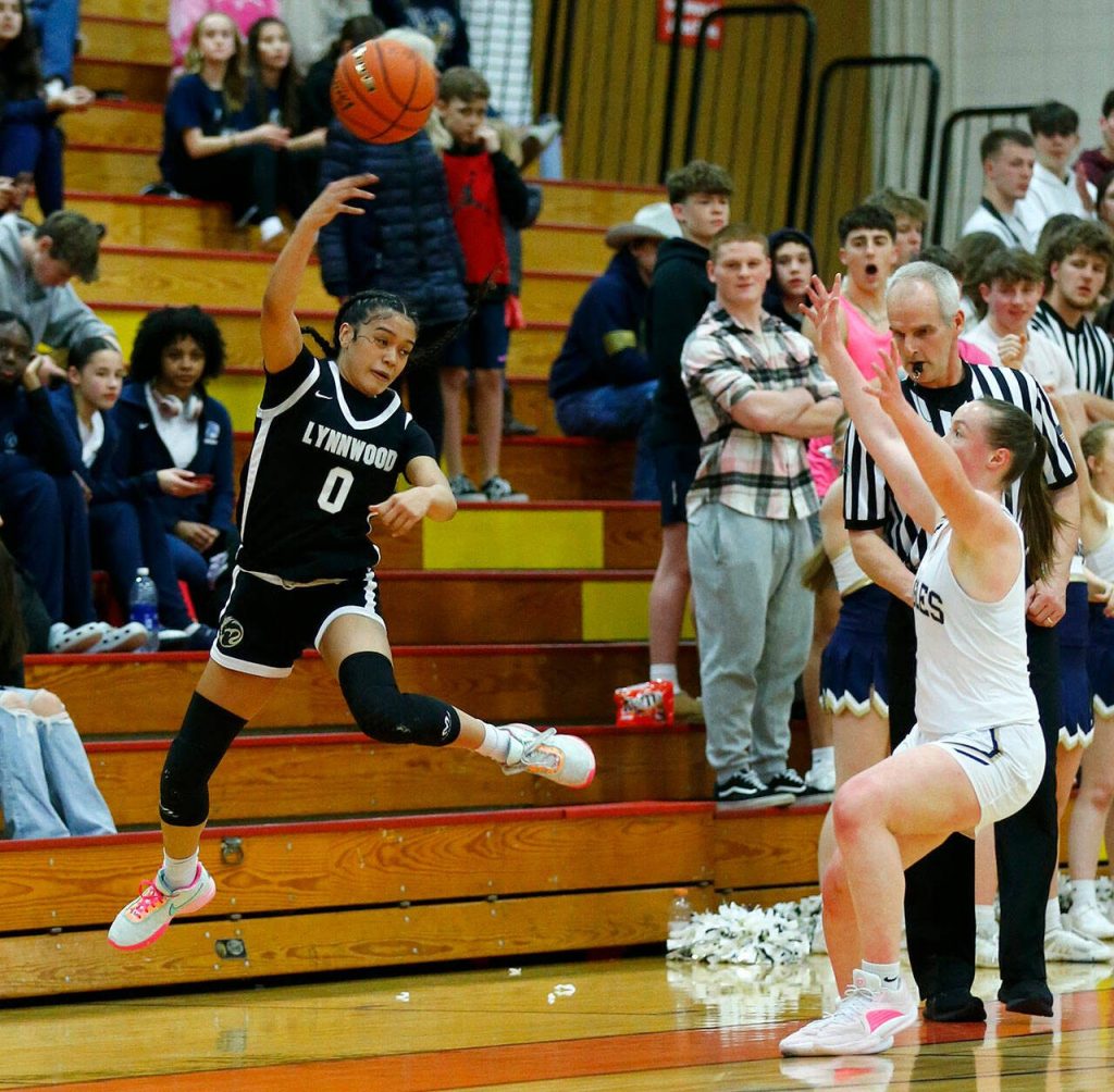Lynnwoods Aniya Hooker saves a loose ball from going out of bounds against Arlington during the 3A District One Semifinals on Wednesday, Feb. 14, 2024, at Marysville Pilchuck High School in Marysville, Washington. (Ryan Berry / The Herald)