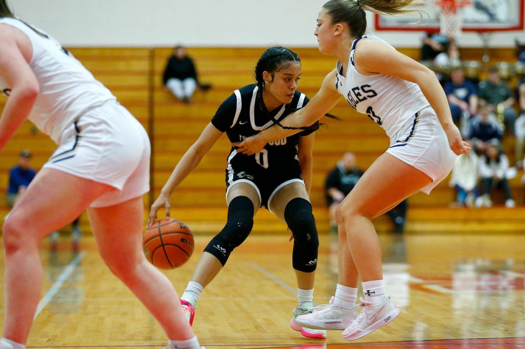 Lynnwoods Aniya Hooker goes around the back to get around a defender against Arlington during the 3A District One Semifinals on Wednesday, Feb. 14, 2024, at Marysville Pilchuck High School in Marysville, Washington. (Ryan Berry / The Herald)
