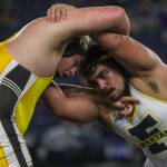 Darrington’s Kade West and Forks’ Sloan Tumaua wrestle during the 1B/2B boys 285-pound championship match during Mat Classic XXXV on Saturday, Feb. 17, 2024, at the Tacoma Dome in Tacoma. (Annie Barker / The Herald)
