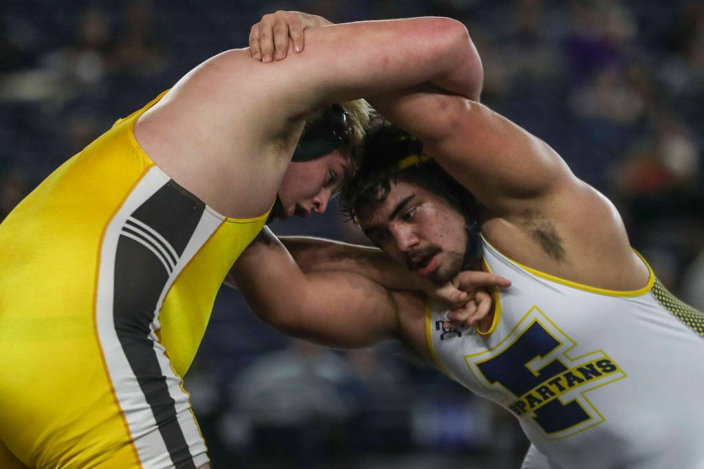 Darrington’s Kade West and Forks’ Sloan Tumaua wrestle during the 1B/2B boys 285-pound championship match during Mat Classic XXXV on Saturday, Feb. 17, 2024, at the Tacoma Dome in Tacoma. (Annie Barker / The Herald)