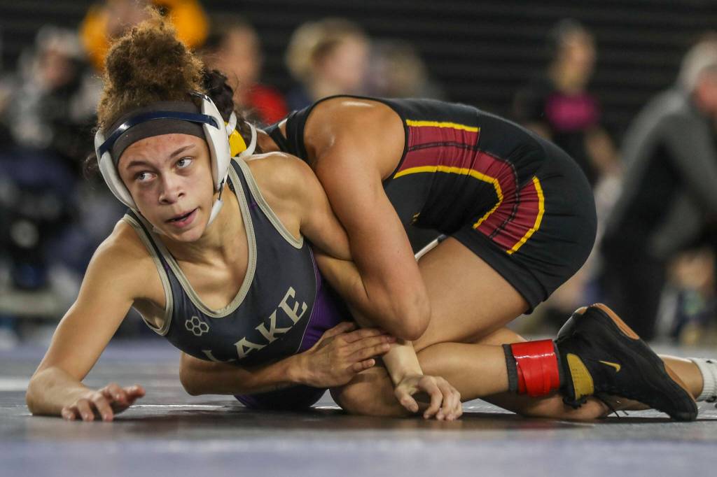 Lake Stevens Kamryn Mason and Moses Lake Ashley Naranjo wrestle during the 4A/3A girls 110-pound championship match during Mat Classic XXXV on Saturday, Feb. 17, 2024, at the Tacoma Dome in Tacoma. (Annie Barker / The Herald)