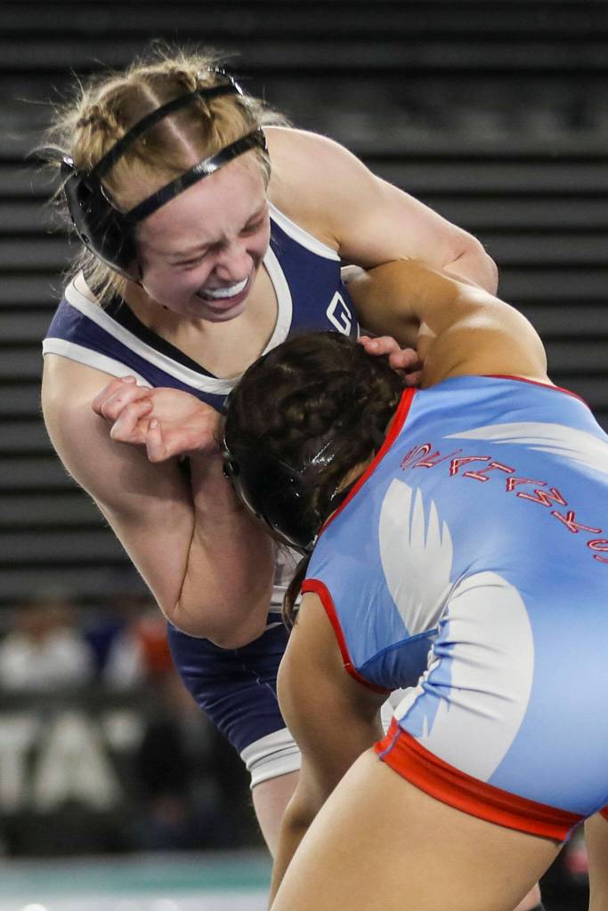 Glacier Peaks Karianne Baldwin and Chief Sealths Sophia Andreini wrestle during the 4A/3A girls 125-pound championship match during Mat Classic XXXV on Saturday, Feb. 17, 2024, at the Tacoma Dome in Tacoma. (Annie Barker / The Herald)