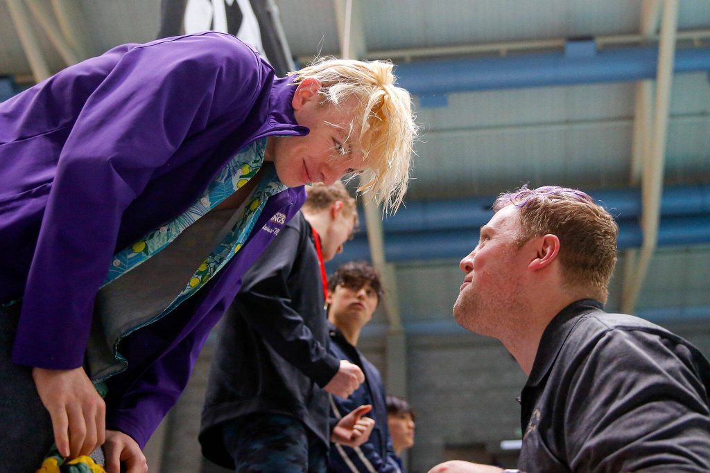 Lake Stevens swimmer Camden Blevins-Mohr receives one of his two first place medals from Lake Stevens head coach Brady Dykgraaf during the WIAA 4A Boys Swim and Dive Championships on Saturday, Feb. 17, 2024, at the Weyerhaeuser King County Aquatic Center in Federal Way, Washington. (Ryan Berry / The Herald)