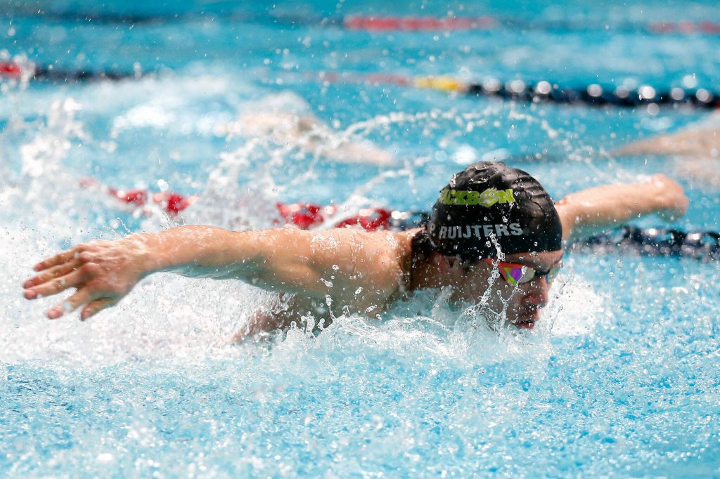 Jacksons Prestyn Ruijters swims the butterfly for his team in the 200 yard medley relay during the WIAA 4A Boys Swim and Dive Championships on Saturday, Feb. 17, 2024, at the Weyerhaeuser King County Aquatic Center in Federal Way, Washington. (Ryan Berry / The Herald)
