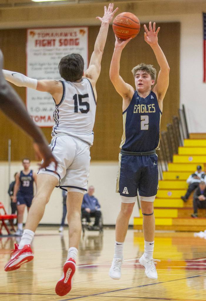 Arlingtons Leyton Martin takes a three point shot during the 3A boys district championship game against Mountlake Terrace on Saturday, Feb. 17, 2024 in Marysville, Washington. (Olivia Vanni / The Herald)