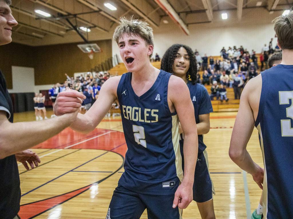 Arlingtons Leyton Martin celebrates beating Mountlake Terrace in the 3A boys district championship game on Saturday, Feb. 17, 2024 in Marysville, Washington. (Olivia Vanni / The Herald)