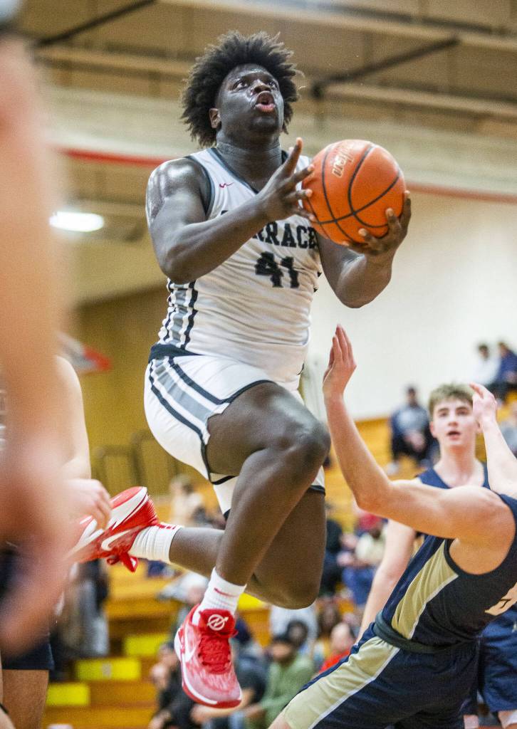 Mountlake Terraces Zaveon Jones leaps in the air while shooting during the 3A boys district championship game against Arlington on Saturday, Feb. 17, 2024 in Marysville, Washington. (Olivia Vanni / The Herald)