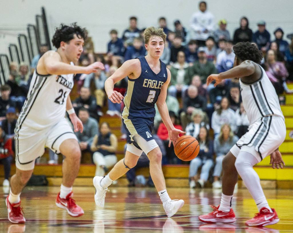 Arlingtons Leyton Martin takes the ball down the court during the 3A boys district championship game against Mountlake Terrace on Saturday, Feb. 17, 2024 in Marysville, Washington. (Olivia Vanni / The Herald)