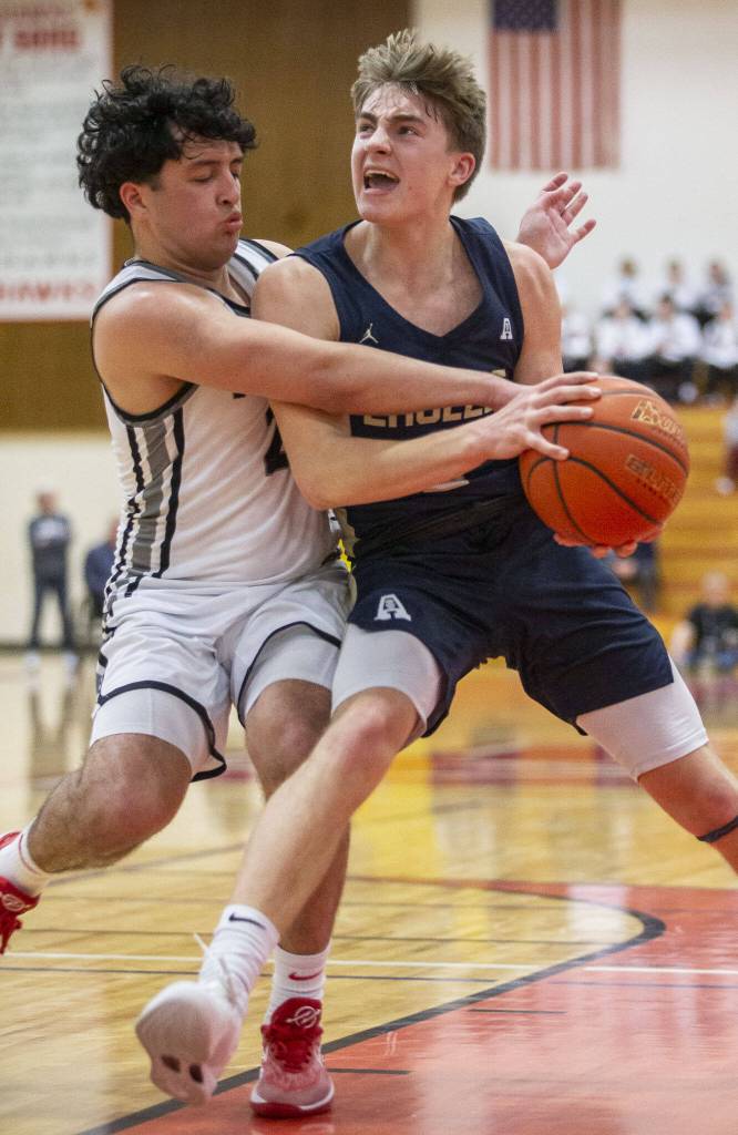 Arlingtons Leyton Martin is fouled while trying to shoot the ball during the 3A boys district championship game against Mountlake Terrace on Saturday, Feb. 17, 2024 in Marysville, Washington. (Olivia Vanni / The Herald)
