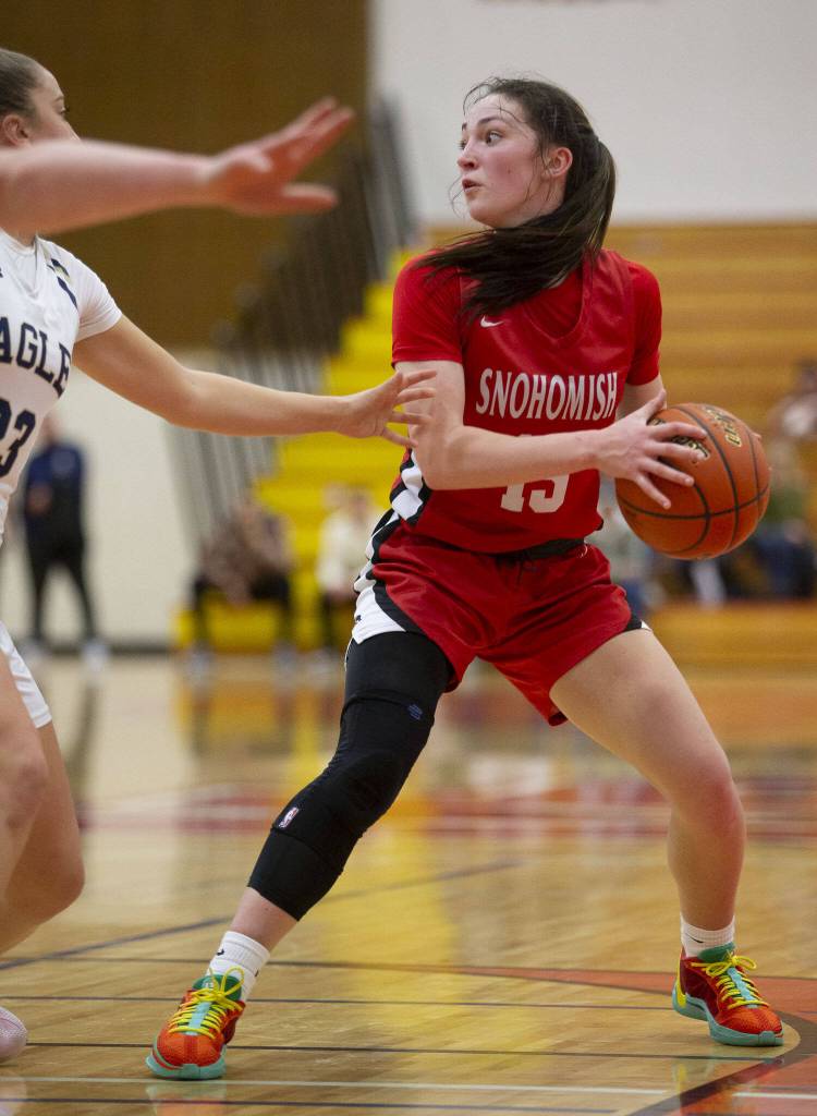 Snohomishs Sienna Capelli looks for an open teammate during the 3A girls district championship game against Arlington on Saturday, Feb. 17, 2024 in Marysville, Washington. (Olivia Vanni / The Herald)