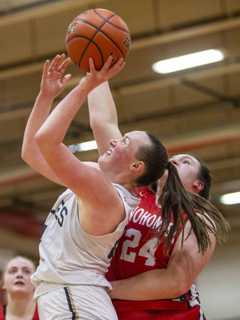 Arlingtons Katie Snow attempts a layup during the 3A girls district championship game against Snohomish on Saturday, Feb. 17, 2024 in Marysville, Washington. (Olivia Vanni / The Herald)