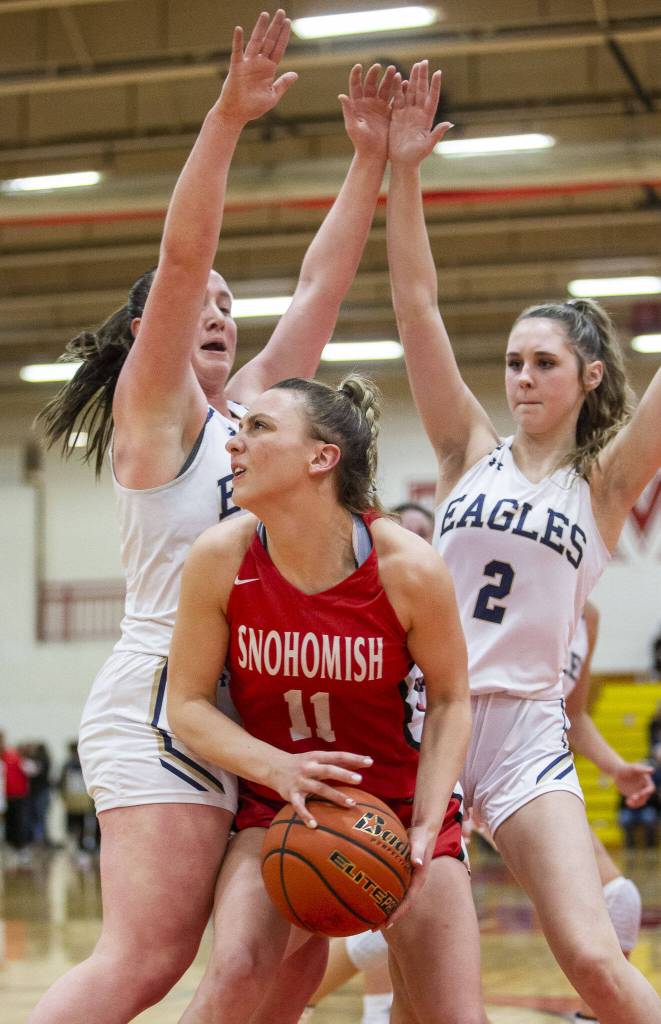 Snohomishs Baella Stich looks for an open shot while being guarded during the 3A girls district championship game against Arlington on Saturday, Feb. 17, 2024 in Marysville, Washington. (Olivia Vanni / The Herald)