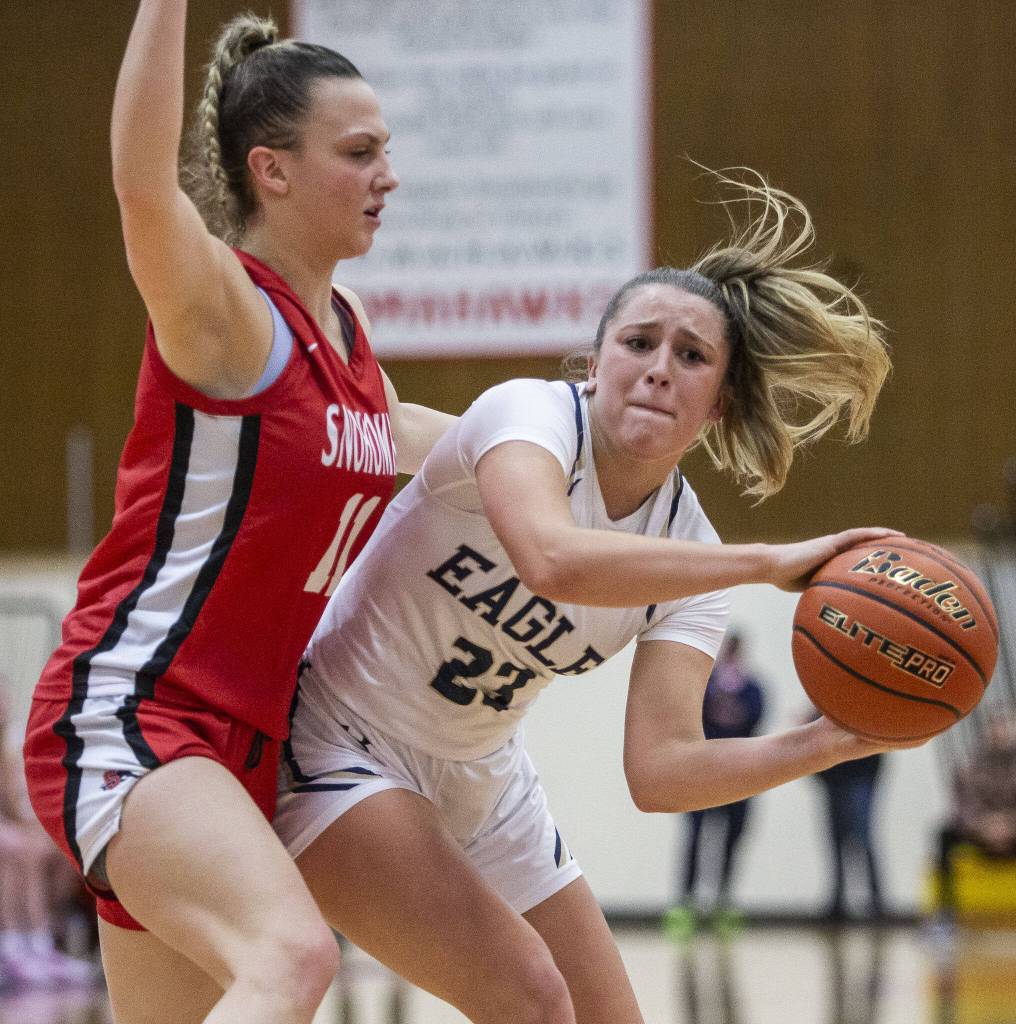 Arlingtons Jersey Walker tries to pass the ball to an open teammate during the 3A girls district championship game against Snohomish on Saturday, Feb. 17, 2024 in Marysville, Washington. (Olivia Vanni / The Herald)
