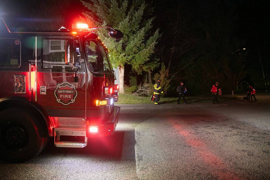 Emergency responders stage outside the Japanese Gulch 19th Street Trailhead while searching for an airplane that crashed in the area on Friday, Feb. 16, 2024, in Everett, Washington. (Ryan Berry / The Herald)