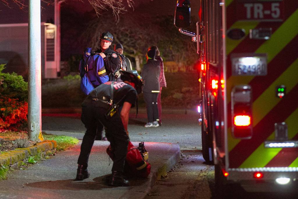 Emergency responders stage outside the Japanese Gulch 19th Street Trailhead while searching for an airplane that crashed in the area on Friday, Feb. 16, 2024, in Everett, Washington. (Ryan Berry / The Herald)
