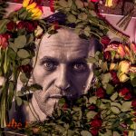 Flowers and a photo of Russian opposition leader Alexei Navalny are placed near the Russian consulate in Frankfurt, Germany, Saturday, Feb. 17, 2024. Navalny, who crusaded against official corruption and staged massive anti-Kremlin protests as President Vladimir Putin's fiercest foe, died Friday in the Arctic penal colony where he was serving a 19-year sentence, Russia's prison agency said. He was 47. (AP Photo/Michael Probst)