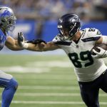 Seattle Seahawks tight end Will Dissly (89) stiff arms Detroit Lions linebacker Alex Anzalone (34) while carrying the ball against the Detroit Lions on Sept. 17, 2023, in Detroit. (AP Photo/Duane Burleson)