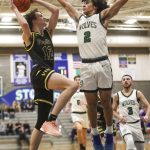 Jacksons Seamus Williams (2) contest a shot against Puyallup during a state regionals game Feb. 23 in Shoreline. (Annie Barker / The Herald)