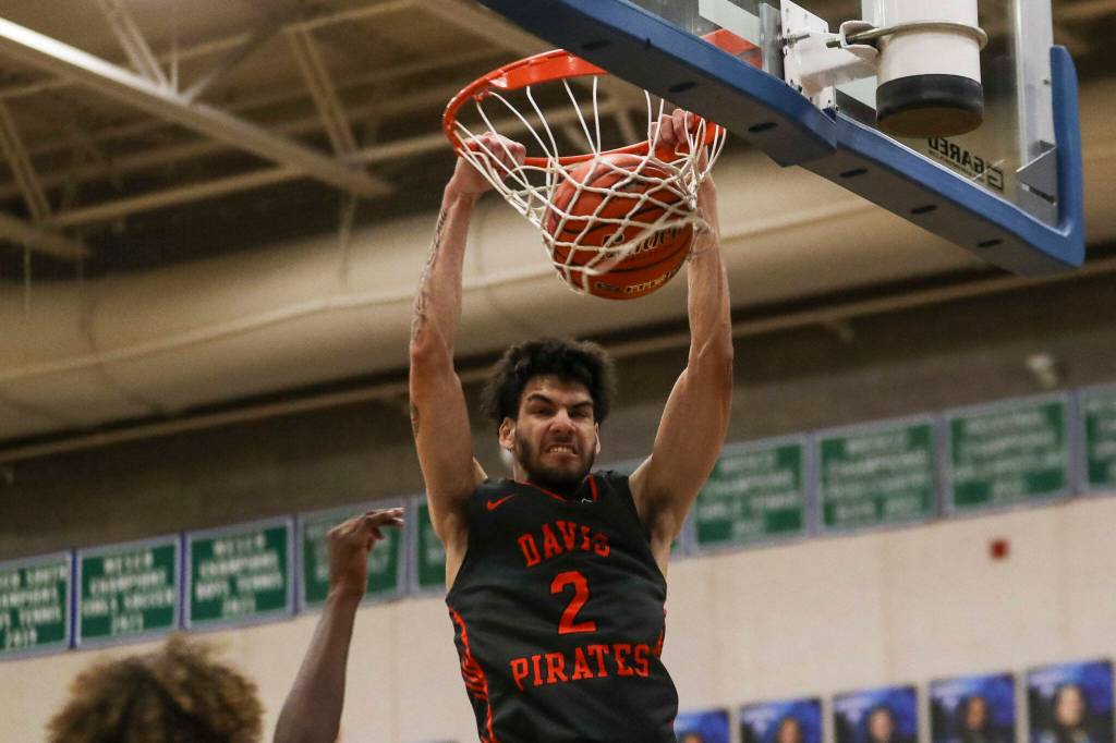 Davis Blake Garza (2) dunks the ball during a boys game between Glacier Peak and Davis at Shorewood High School on Friday, Feb. 23, 2024, in Shoreline, WA. Glacier Peak fell, 65-54.. (Annie Barker / The Herald)