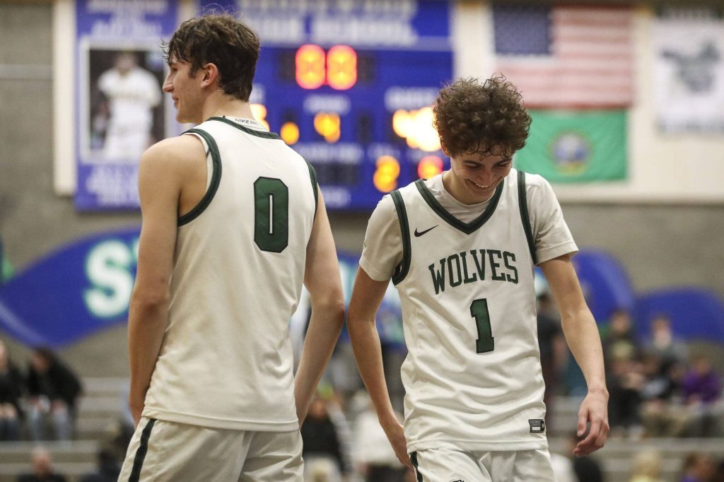 Jackson players celebrate during a boys game between Jackson and Puyallup at Shorewood High School on Friday, Feb. 23, 2024, in Shoreline, WA. Jackson won, 55-48. (Annie Barker / The Herald)
