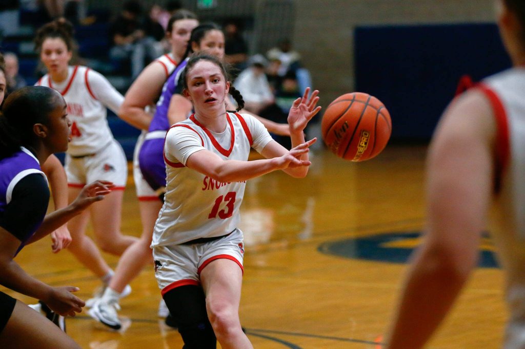 Snohomishs Sienna Capelli distributes to a teammate against Garfield during a playoff matchup at Arlington High School on Friday, Feb. 23, 2024, in Arlington, Washington. (Ryan Berry / The Herald)