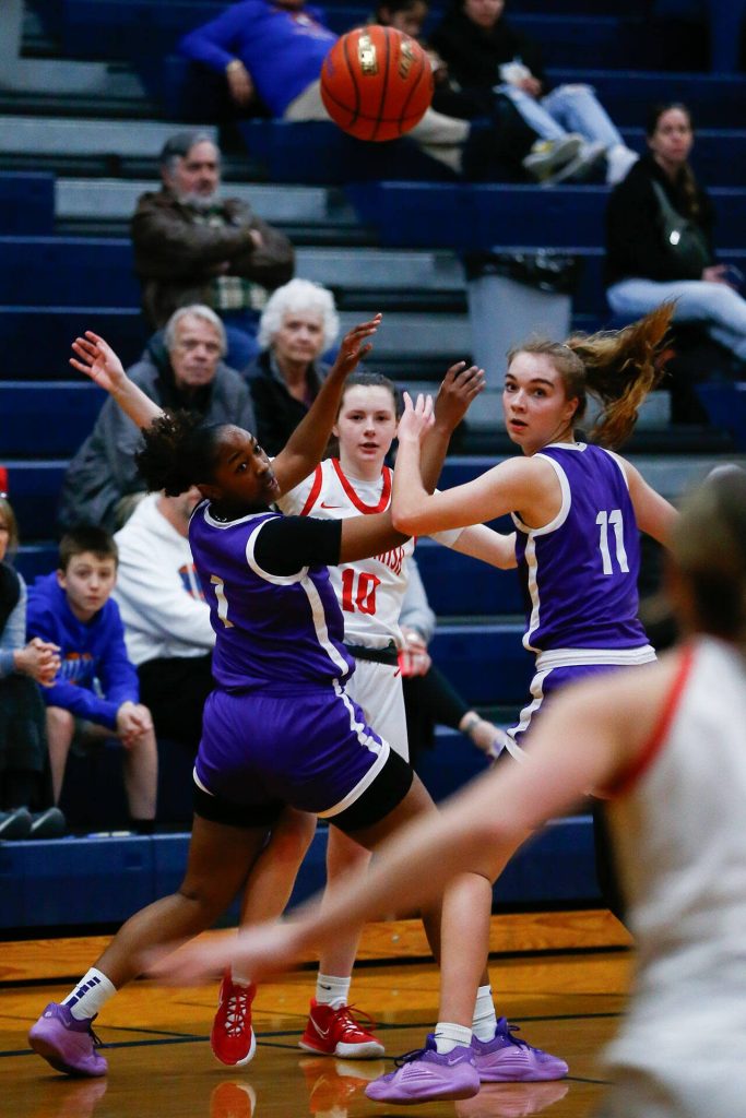 Snohomish junior Cora Larson passes out of a double team against Garfield during a playoff matchup at Arlington High School on Friday, Feb. 23, 2024, in Arlington, Washington. (Ryan Berry / The Herald)