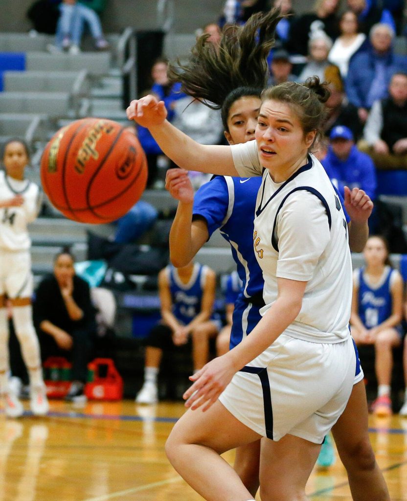 Everett senior Lanie Thompson turns and watches a loose rebound fly out of bounds during a playoff matchup against Seattle Prep at Shorewood High School on Saturday, Feb. 24, 2024, in Shoreline, Washington. (Ryan Berry / The Herald)