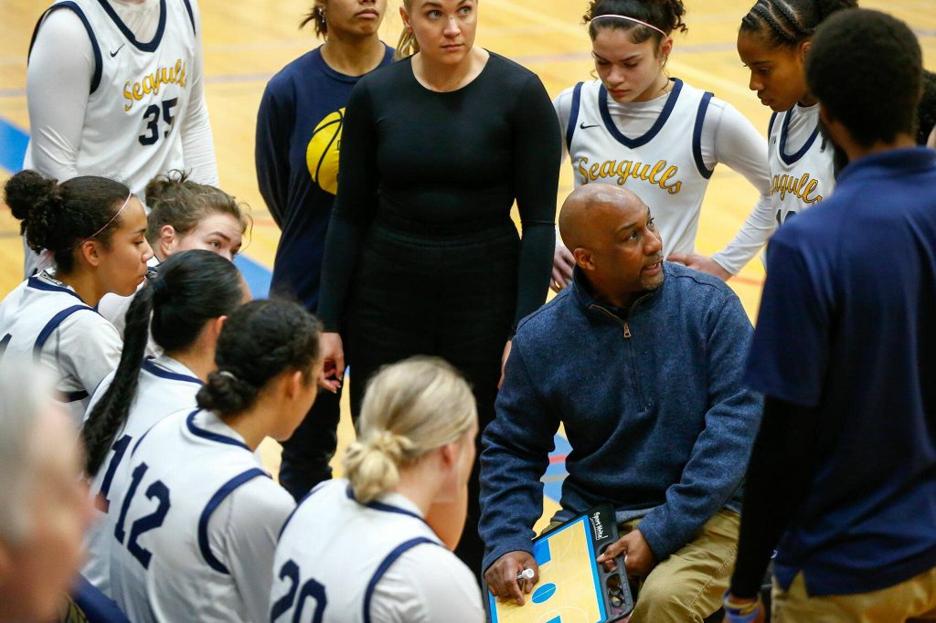 Everett head coach Darrell McNeal gathers his team during a time-out in the fourth quarter of a playoff game against Seattle Prep at Shorewood High School on Saturday, Feb. 24, 2024, in Shoreline, Washington. (Ryan Berry / The Herald)
