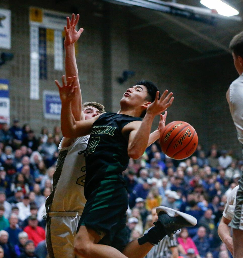 Marysville Getchells Bubba Palocol loses the ball while trying to score against Arlington during a playoff matchup at Arlington High School on Saturday, Feb. 24, 2024, in Arlington, Washington. (Ryan Berry / The Herald)