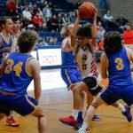 Tulalip Heritage freshman Amare Hatch tries to force his way to the rim against Columbia Adventist Academy during a playoff matchup at Arlington High School on Saturday, Feb. 24, 2024, in Arlington, Washington. (Ryan Berry / The Herald)
