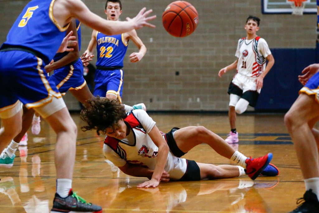 Tulalip Heritage freshman Amare Hatch hits the ground after getting fouled against Columbia Adventist Academy during a playoff matchup at Arlington High School on Saturday, Feb. 24, 2024, in Arlington, Washington. (Ryan Berry / The Herald)