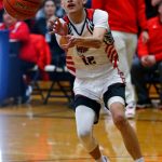 Tulalip Heritage senior Adrian Jefferson passes down low to a teammate against Columbia Adventist Academy during a playoff matchup at Arlington High School on Saturday, Feb. 24, 2024, in Arlington, Washington. (Ryan Berry / The Herald)