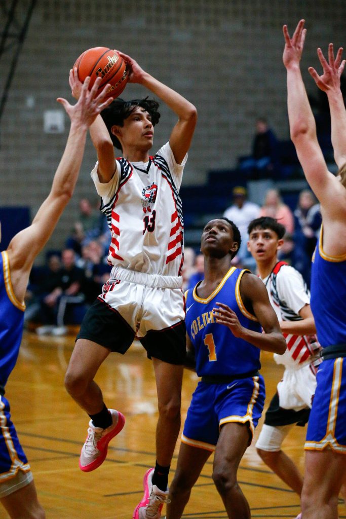 Tulalip Heritages Tokala Black Tomahawk pulls up and shoots a mid range shot against Columbia Adventist Academy during a playoff matchup at Arlington High School on Saturday, Feb. 24, 2024, in Arlington, Washington. (Ryan Berry / The Herald)