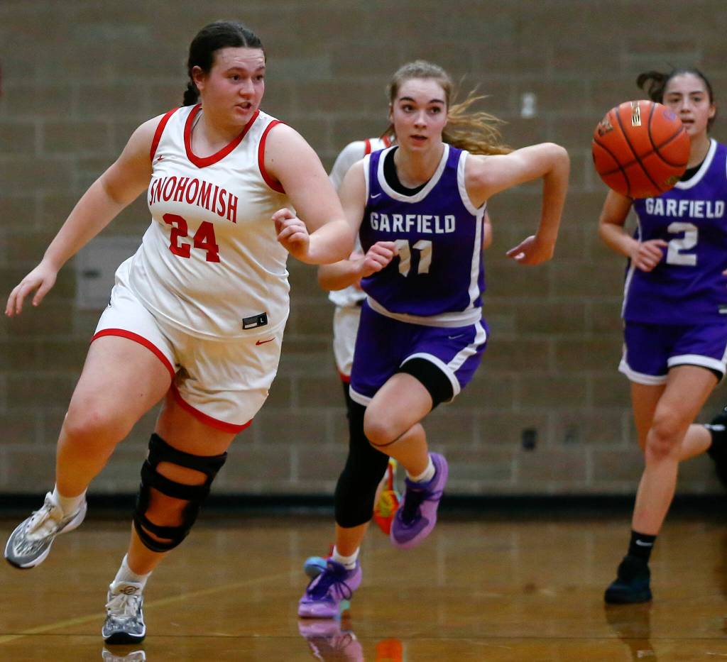Snohomish senior Addyson Gallatin chases down a loose ball during a playoff matchup with Garfield on Feb. 23 in Arlington. (Ryan Berry / The Herald)