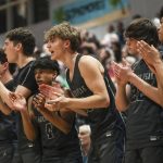 Glacier Peak players cheer during a boys bi-district title game against Mount Si on Feb. 16 at North Creek High School in Bothell. (Annie Barker / The Herald)