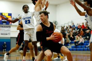 Everett Community College’s Derek Smith tries to spin out of trouble in the lane against Edmonds College on Wednesday, Feb. 7, 2024, at Seaview Gym in Lynnwood, Washington. (Ryan Berry / The Herald)