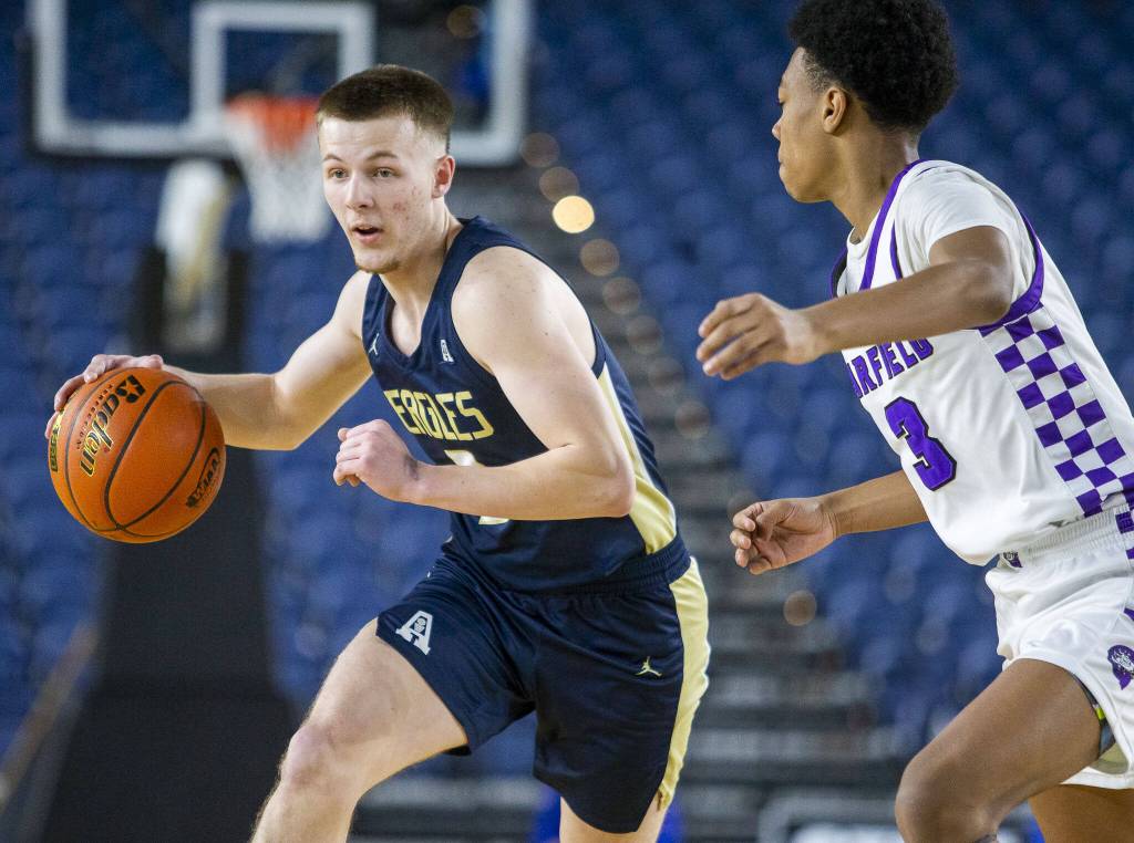 Arlingtons Jackson Trotter takes the ball down the court during the 3A boys state basketball game against Garfield on Wednesday, Feb. 28, 2024 in Tacoma, Washington. (Olivia Vanni / The Herald)