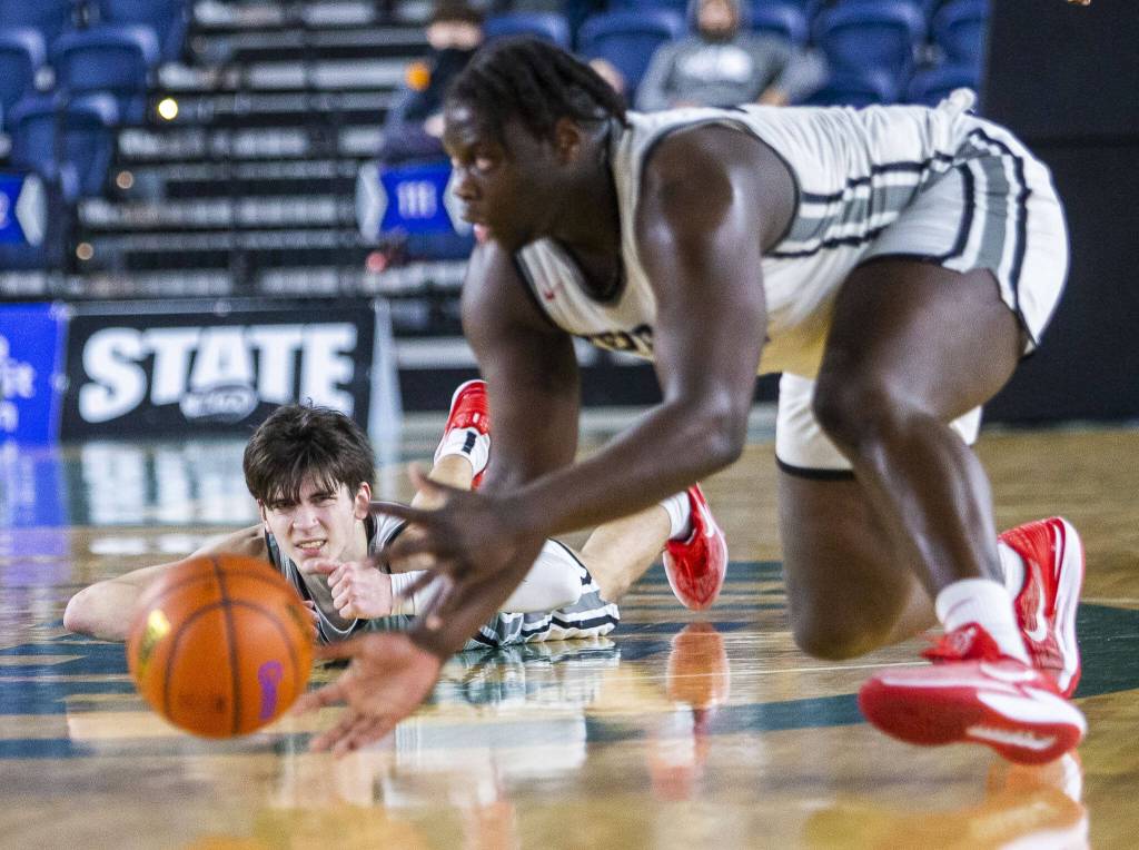 Mountlake Terraces Jaxon Dubiel grimaces after tripping at losing the ball during the 3A boys state basketball game against Todd Beamer on Wednesday, Feb. 28, 2024 in Tacoma, Washington. (Olivia Vanni / The Herald)