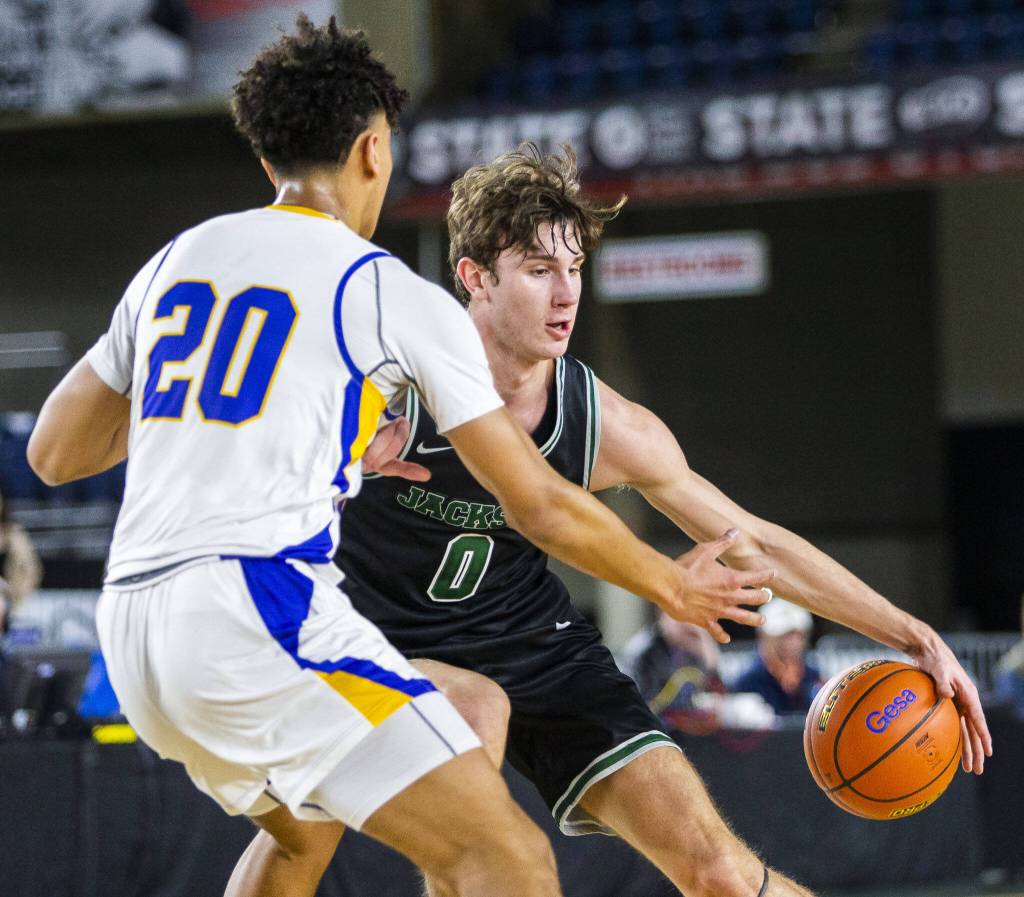 Jacksons Ryan Mcferran maneuvers around Tahomas Jayden Stephens during the 4A boys state basketball game against Tahoma on Wednesday, Feb. 28, 2024 in Tacoma, Washington. (Olivia Vanni / The Herald)