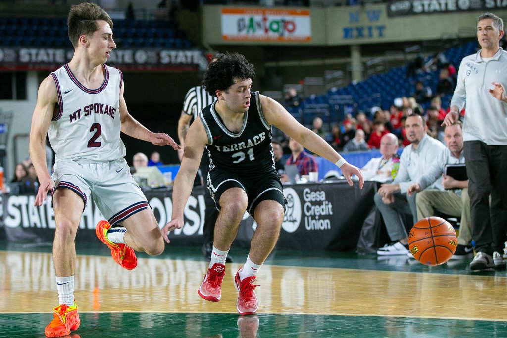 Mountlake Terraces Logan Tews keeps possession of a loose ball during a WIAA 3A Boys Basketball quarterfinal against Mount Spokane on Thursday, Feb. 29, 2024, at the Tacoma Dome in Tacoma, Washington. (Ryan Berry / The Herald)