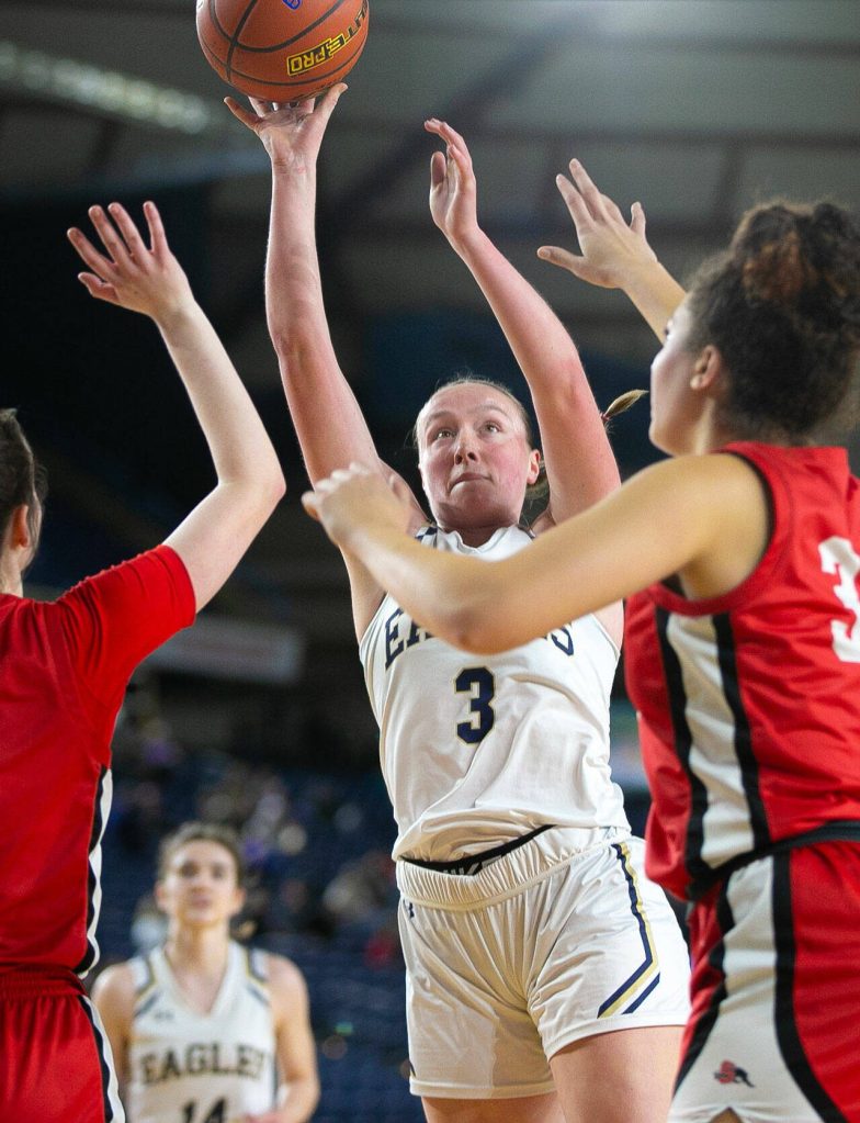 Arlington senior Rachel Snow shoots over two defenders during a WIAA 3A Girls Basketball quarterfinal against Snohomish on Thursday, Feb. 29, 2024, at the Tacoma Dome in Tacoma, Washington. (Ryan Berry / The Herald)
