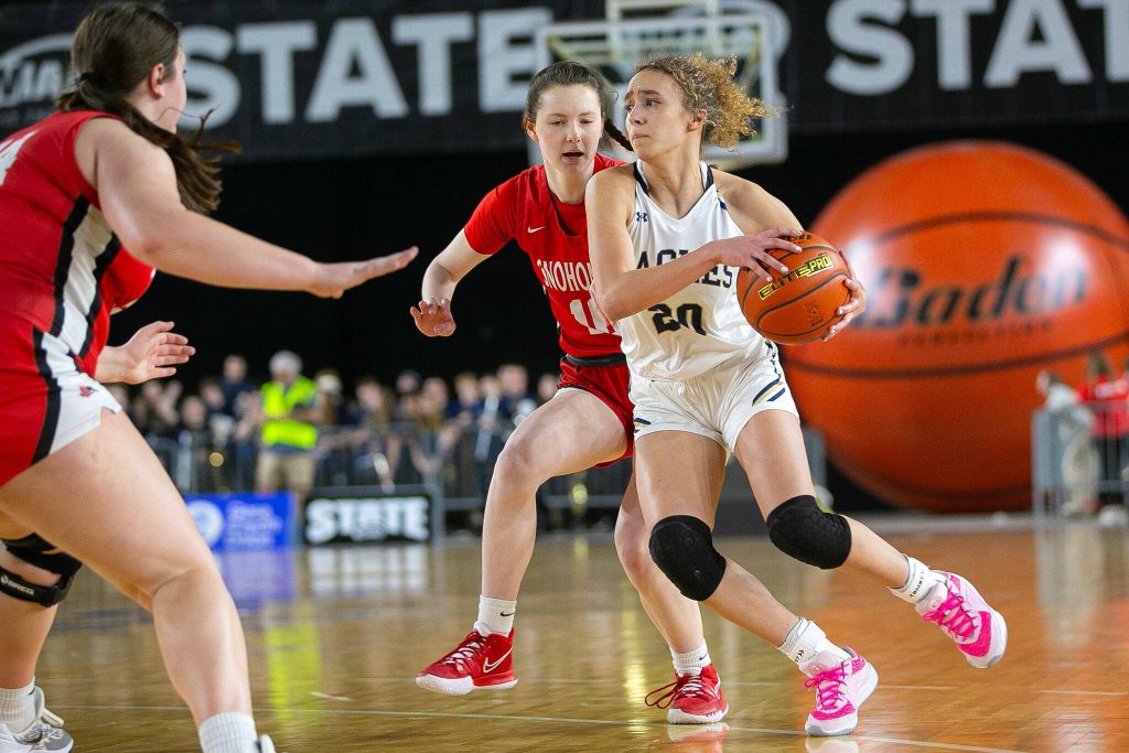 Arlingtons Samara Morrow handles the ball and looks for a pass during a WIAA 3A Girls Basketball quarterfinal against Snohomish on Thursday, Feb. 29, 2024, at the Tacoma Dome in Tacoma, Washington. (Ryan Berry / The Herald)