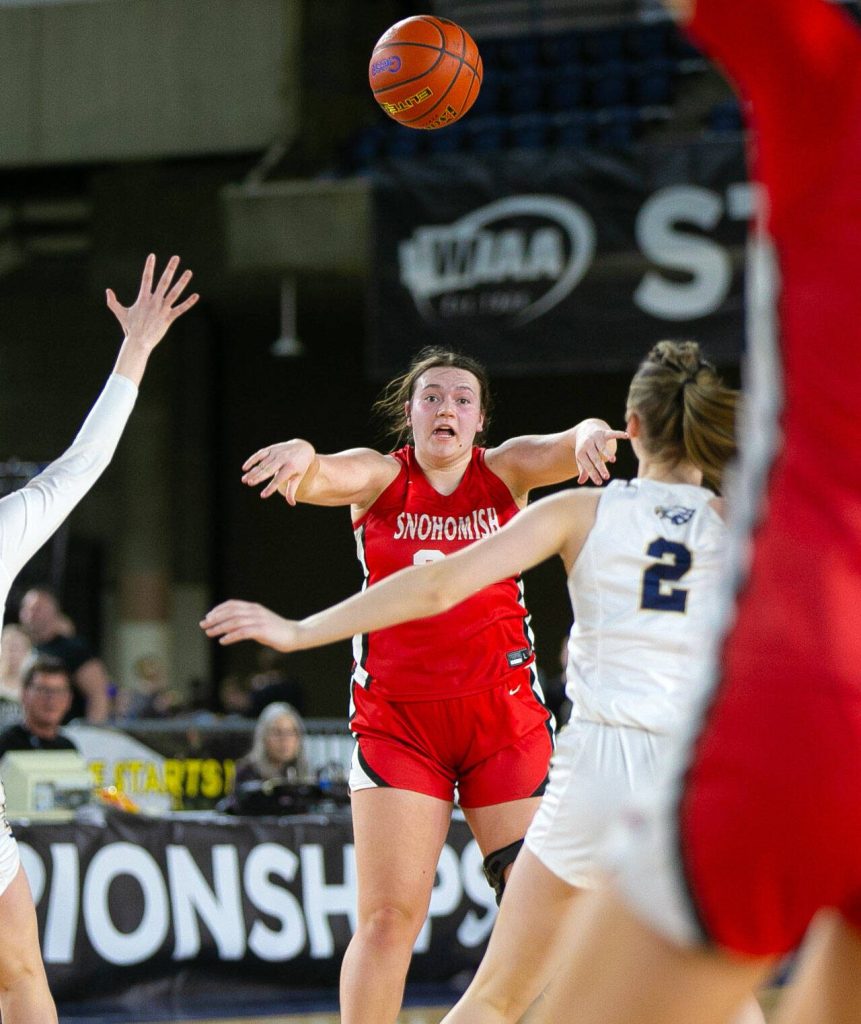 Snohomish senior Addyson Gallatin passes down to the paint during a WIAA 3A Girls Basketball quarterfinal against Arlington on Thursday, Feb. 29, 2024, at the Tacoma Dome in Tacoma, Washington. (Ryan Berry / The Herald)