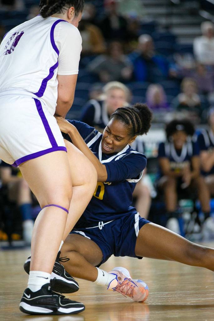 Everett sophomore Akila Shaw ties up the ball during a WIAA 3A Girls Basketball quarterfinal against Garfield on Thursday, Feb. 29, 2024, at the Tacoma Dome in Tacoma, Washington. (Ryan Berry / The Herald)