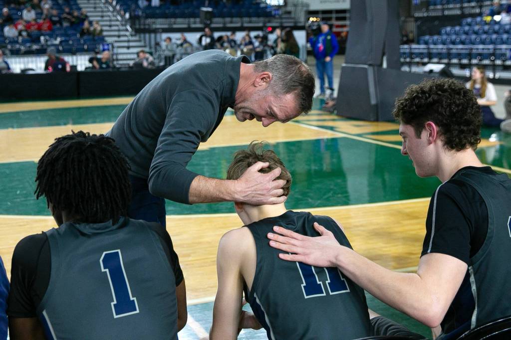 Glacier Peak head coach Brian Hunter speaks positively to sophomore Reed Nagel after Nagel fouled out during a WIAA 4A Boys Basketball quarterfinal against Gonzaga Prep on Thursday, Feb. 29, 2024, at the Tacoma Dome in Tacoma, Washington. (Ryan Berry / The Herald)