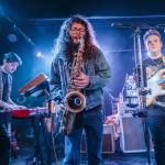 Brandon Hailey of Cytrus, center, plays the saxophone during a headlining show at Madame Lous on Friday, Dec. 29, 2023 in Seattle, Washington. (Olivia Vanni / The Herald)