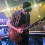 Owen Mayo of Cytrus picks up his guitar to play during a headlining show at Madame Lous on Friday, Dec. 29, 2023 in Seattle, Washington. (Olivia Vanni / The Herald)