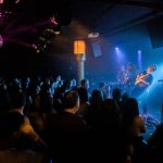 Jared Squires of Cytrus leans back while playing guitar during a headlining show at Madame Lous on Friday, Dec. 29, 2023 in Seattle, Washington. (Olivia Vanni / The Herald)