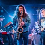 Brandon Hailey of Cytrus, center, plays the saxophone during a headlining show at Madam Lou’s on Friday, Dec. 29, 2023 in Seattle, Washington. (Olivia Vanni / The Herald)